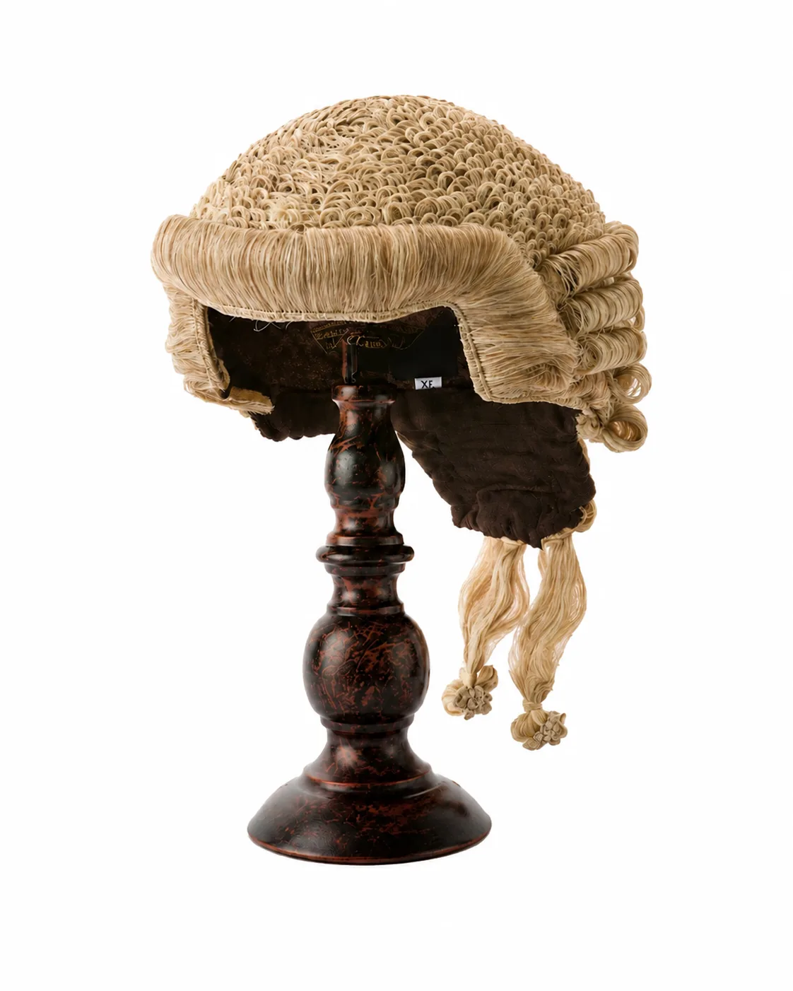 A barrister's ceremonial court wig on a wooden stand